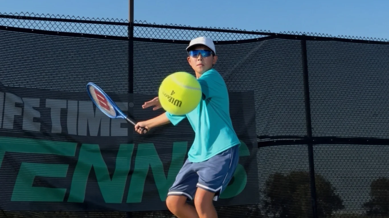Tennis player preparing to hit a ball on an outdoor court