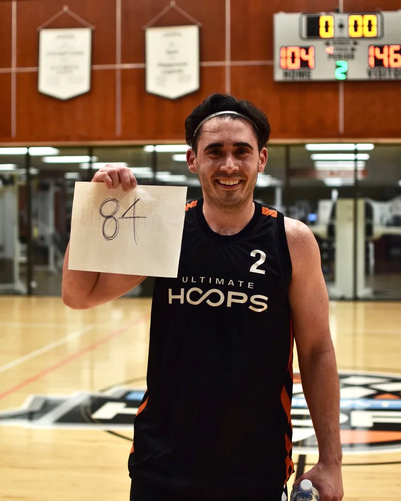 Coach Evan Pastorelle on a basketball court