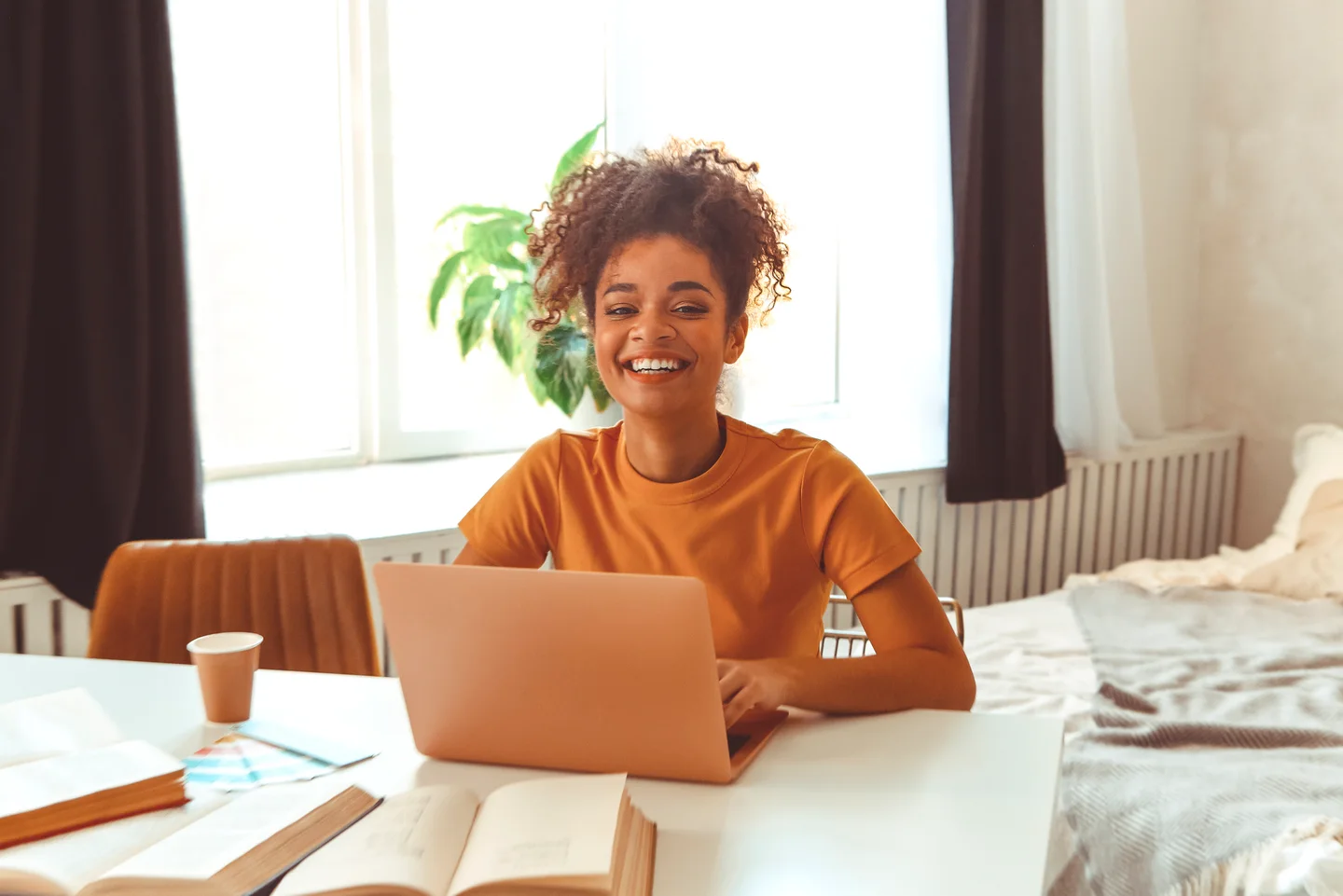 Student studying at home with a laptop